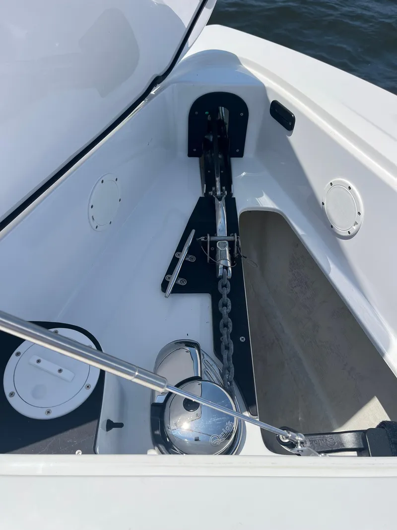 Slide: The Image of 2024 Nor-Tech 390 Sport Center Console anchor compartment with chain and winch. - 18
