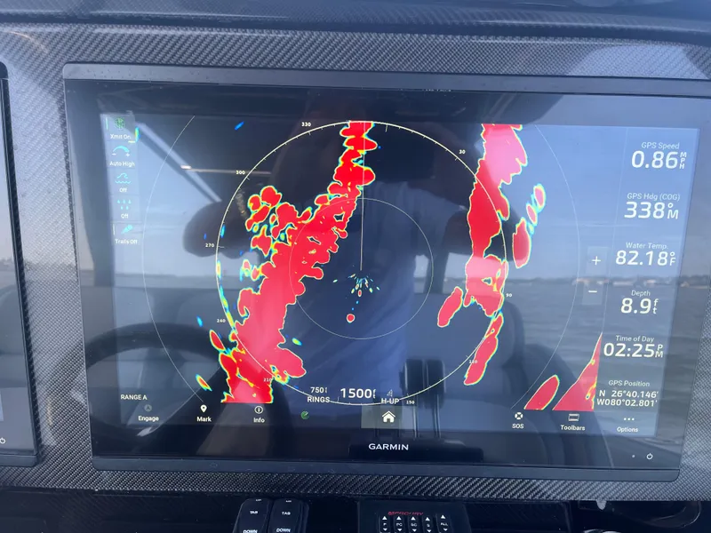 Slide: The Image of 2024 Nor-Tech 390 Sport Center Console with Garmin radar display showing navigation data. - 21