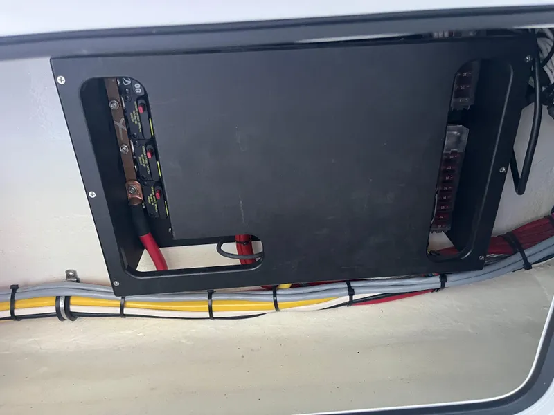 Slide: The Image of Electrical panel inside 2024 Nor-Tech 390 Sport Center Console boat. - 24