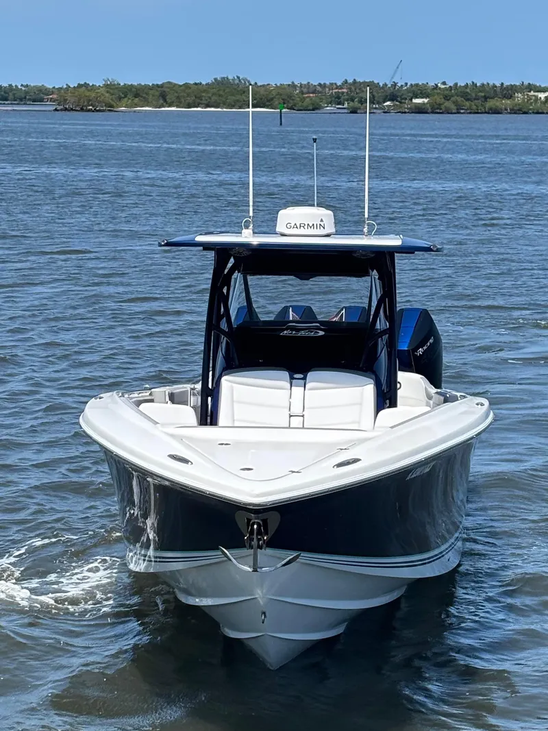 Slide: The Image of 2024 Nor-Tech 390 Sport Center Console boat on water, front view. - 3