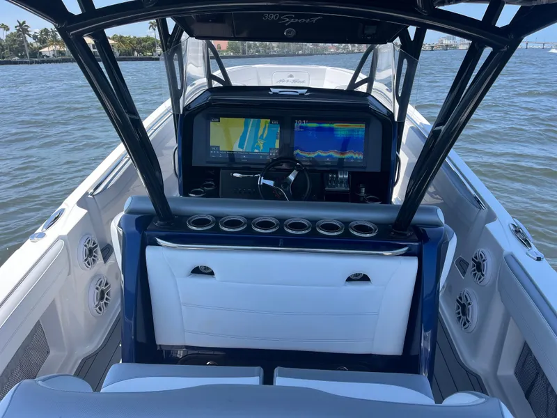 Slide: The Image of 2024 Nor-Tech 390 Sport Center Console boat with advanced navigation system on open water. - 8