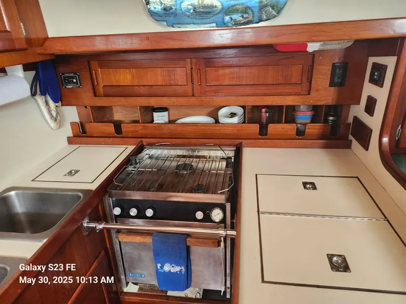 Slide: The Image of 1989 Valiant 40 Cutter kitchen with stove, sink, and wooden cabinetry. - 17
