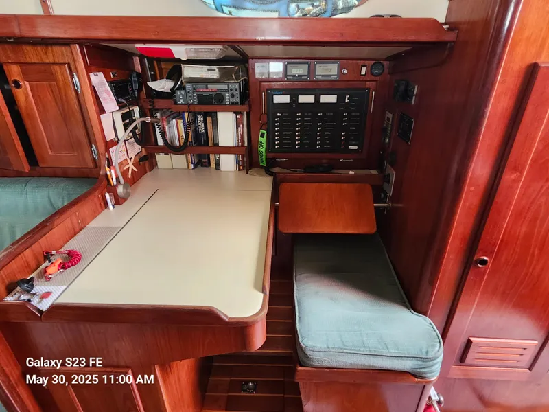 Slide: The Image of Navigation station inside 1989 Valiant 40 Cutter, featuring control panel and seating. - 20