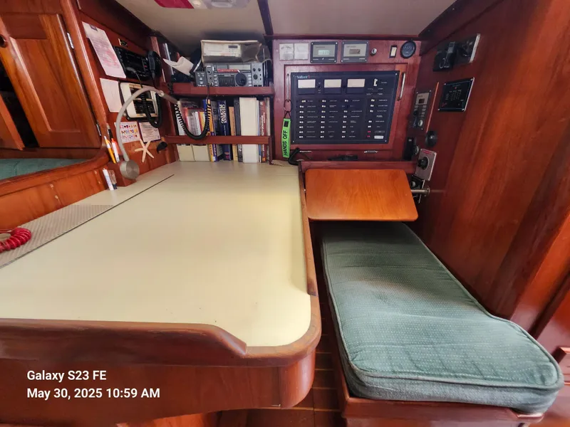 Slide: The Image of Navigation station inside 1989 Valiant 40 Cutter, featuring control panel and seating area. - 21