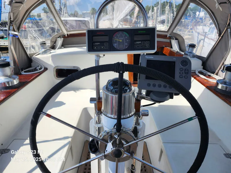 Slide: The Image of Cockpit of 1989 Valiant 40 Cutter sailboat with steering wheel and navigation instruments. - 26