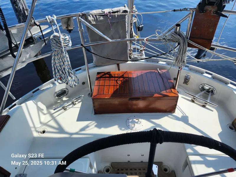 Slide: The Image of Cockpit of 1989 Valiant 40 Cutter sailboat with wooden storage box and nautical equipment. - 29