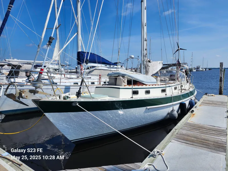 Slide: The Image of 1989 Valiant 40 Cutter sailboat docked at marina under clear blue sky. - 3