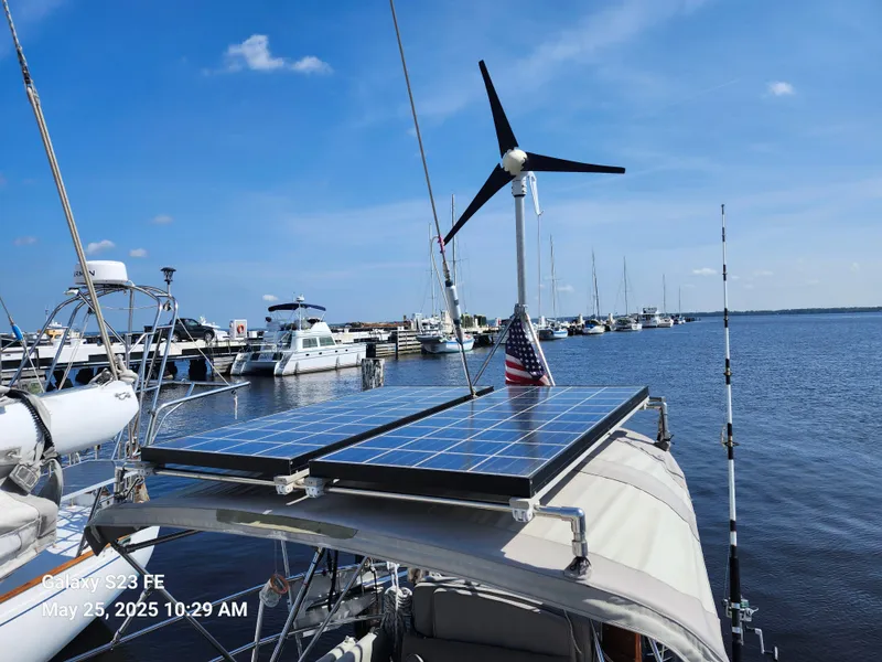 Slide: The Image of Valiant 40 Cutter sailboat with solar panels and wind turbine at marina, May 2025. - 32
