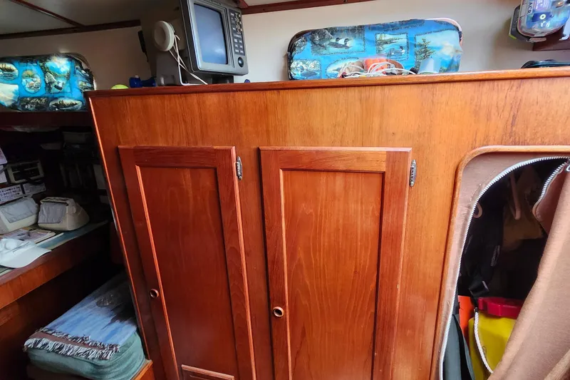 Slide: The Image of 1989 Valiant 40 Cutter interior with wooden cabinets and nautical decor. - 33