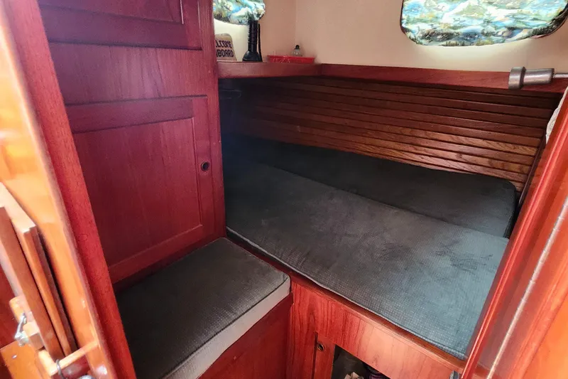 Slide: The Image of Cozy cabin interior of 1989 Valiant 40 Cutter with wooden finish and cushioned seating. - 34