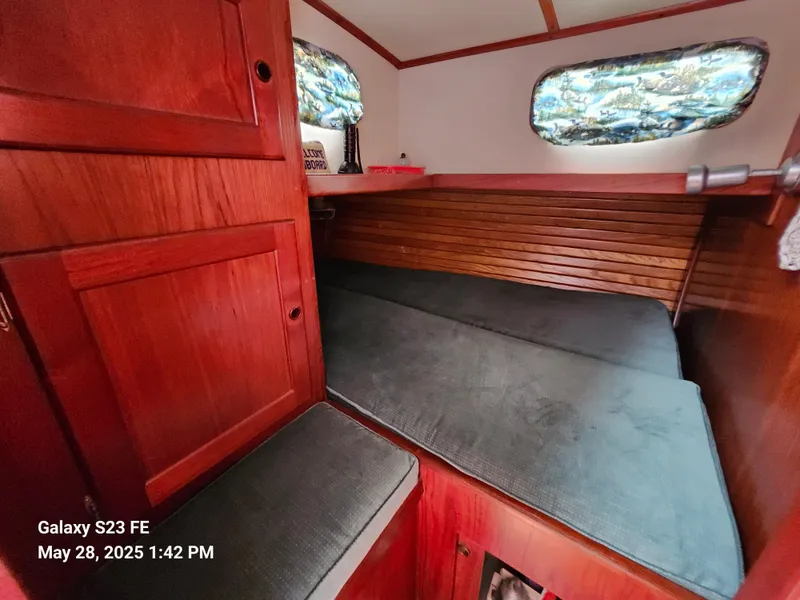 Slide: The Image of Interior of 1989 Valiant 40 Cutter with wooden cabinetry and cushioned seating. - 35