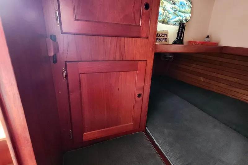 Slide: The Image of Interior of 1989 Valiant 40 Cutter with wooden cabinetry and cozy seating area. - 36