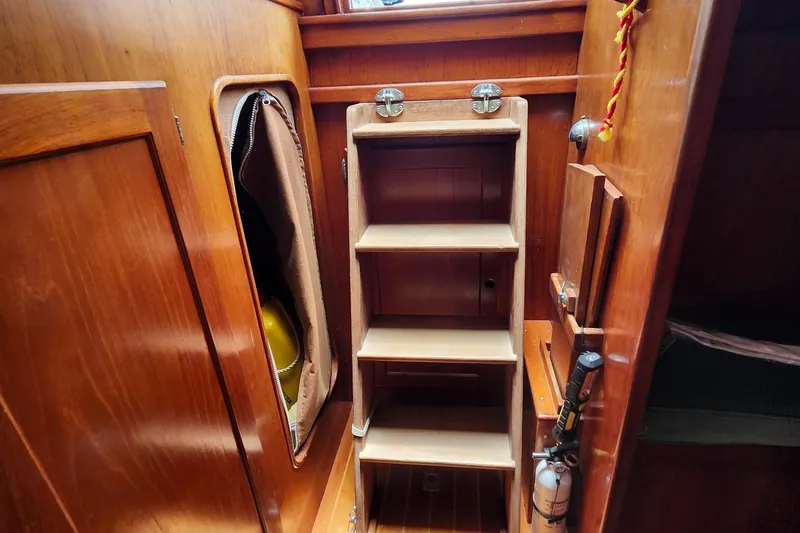Slide: The Image of Interior of 1989 Valiant 40 Cutter showing wooden cabinetry and storage shelves. - 39