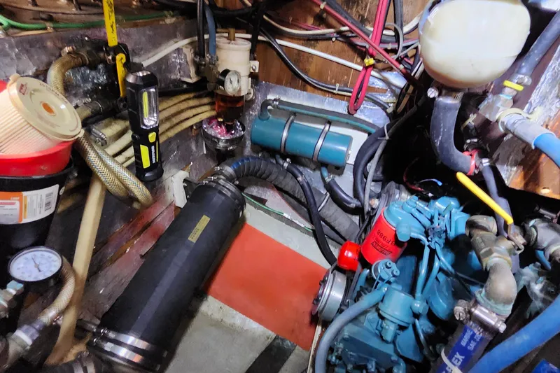 Slide: The Image of Engine room of a 1989 Valiant 40 Cutter, showcasing various mechanical components and wiring. - 43