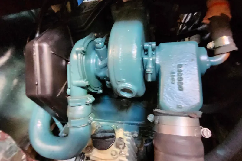 Slide: The Image of Engine components of a 1989 Valiant 40 Cutter, featuring blue and black parts. - 48