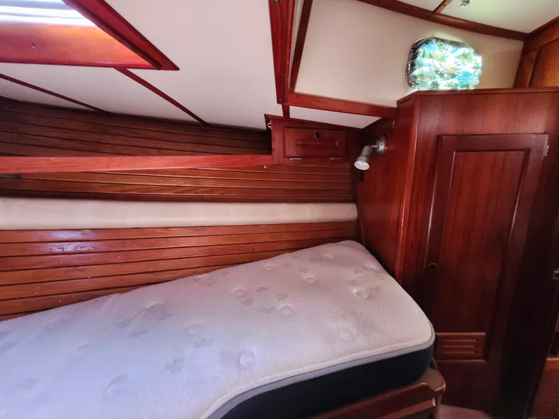 Slide: The Image of Cozy cabin interior of 1989 Valiant 40 Cutter with wooden paneling and mattress. - 51
