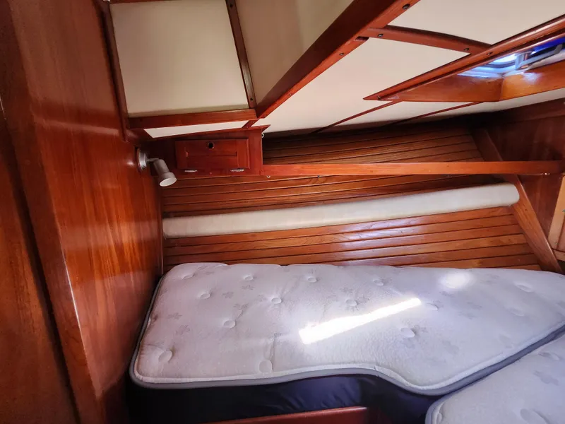 Slide: The Image of Cozy cabin interior of 1989 Valiant 40 Cutter with wooden paneling and mattress. - 53