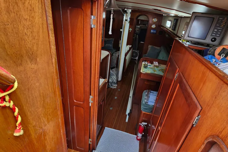 Slide: The Image of Interior of 1989 Valiant 40 Cutter sailboat with wooden cabinetry and navigation equipment. - 6