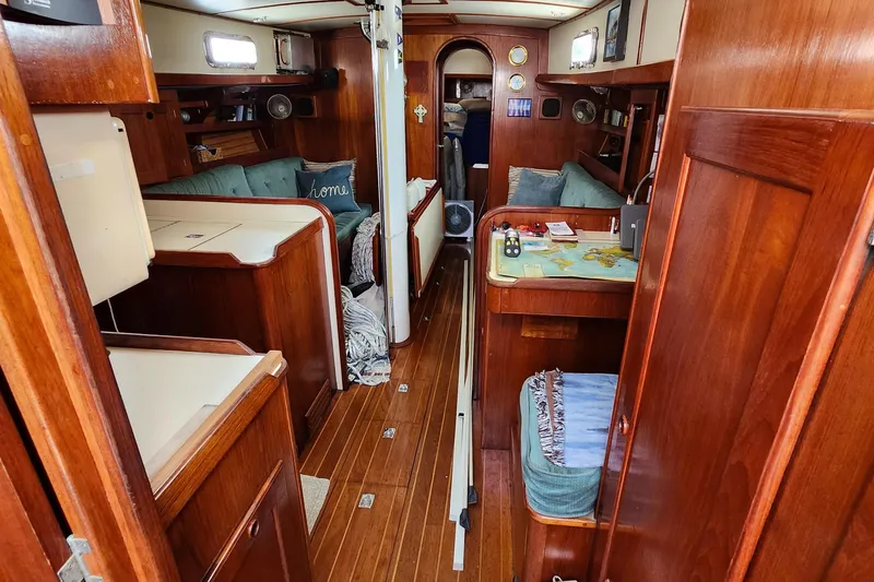 Slide: The Image of 1989 Valiant 40 Cutter interior with wooden finish, cozy seating, and nautical decor. - 7