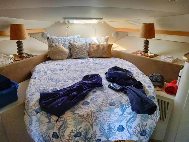 Slide: The Image of Cozy cabin interior of 1994 Carver 380 Santego with nautical-themed bedding and decor. - 10