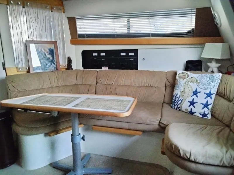 Slide: The Image of Interior of 1994 Carver 380 Santego yacht with beige seating and nautical decor. - 12