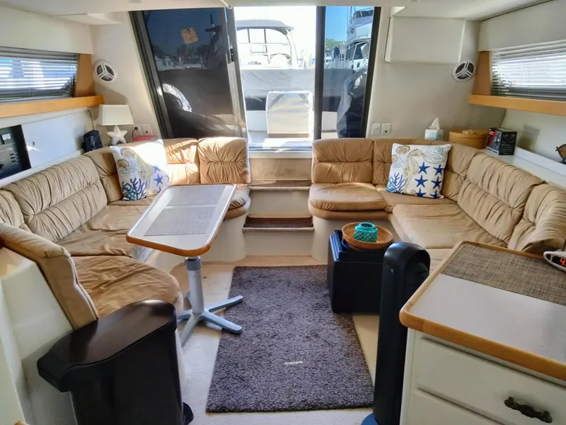 Slide: The Image of Interior of a 1994 Carver 380 Santego yacht with cozy seating and nautical decor. - 13