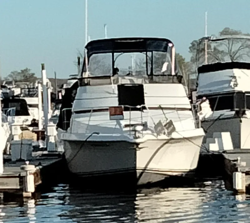 Slide: The Image of 1994 Carver 380 Santego yacht docked at a marina, surrounded by other boats. - 4