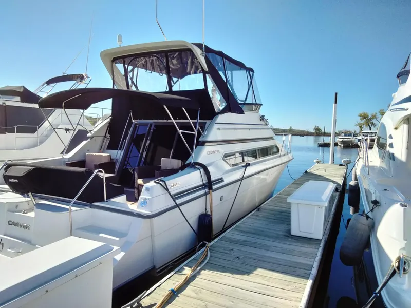 Slide: The Image of 1994 Carver 380 Santego yacht docked at marina under clear blue sky. - 5