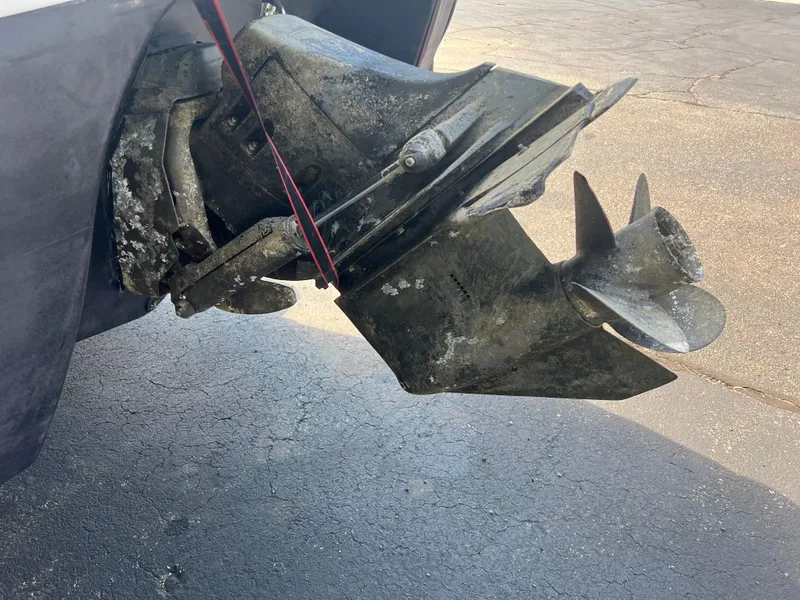 Slide: The Image of Outboard motor of a 1997 Chris-Craft 26 Crowne Cruiser on pavement. - 4