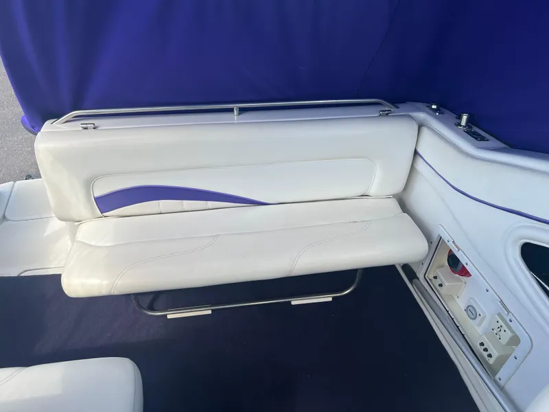 Slide: The Image of 1997 Chris-Craft 26 Crowne Cruiser interior with white and blue seating. - 6