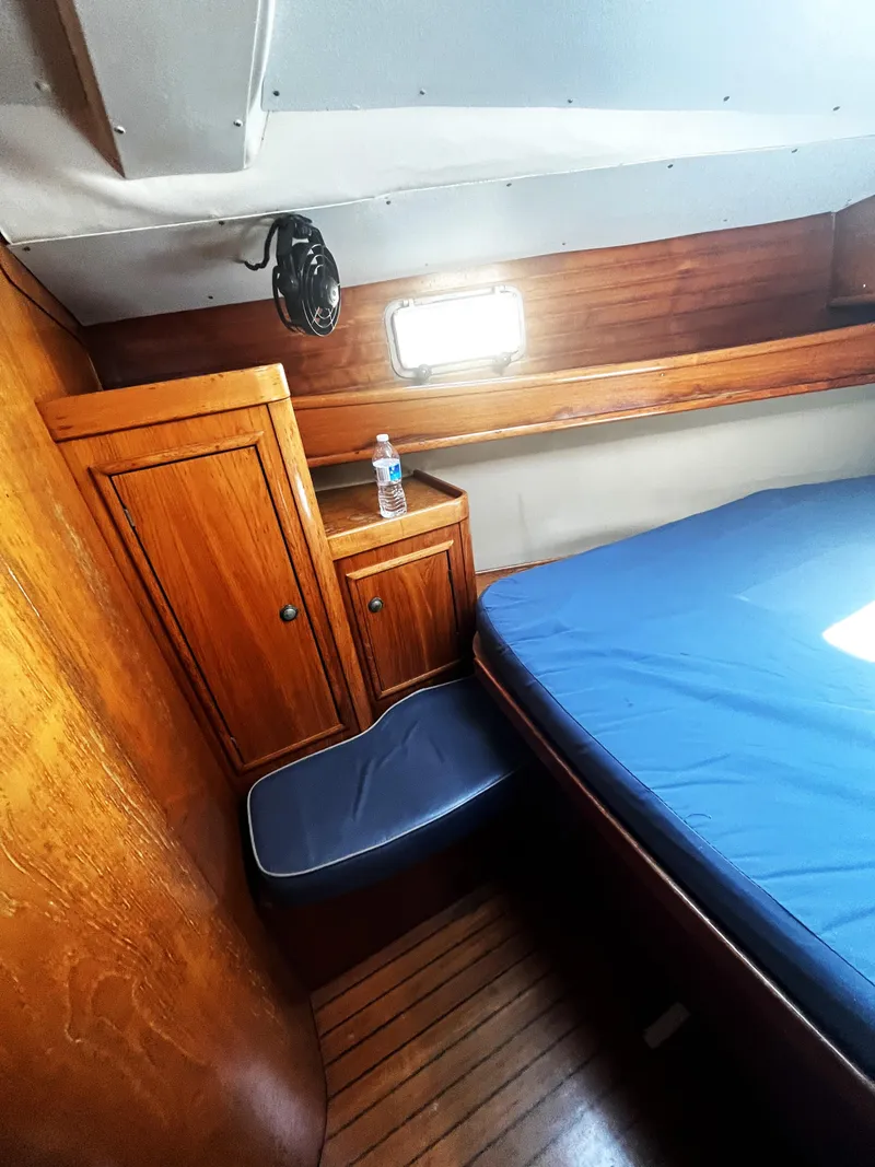 Slide: The Image of Cozy cabin interior of 1990 Jeanneau Sun Magic 44 sailboat with wooden furnishings. - 10