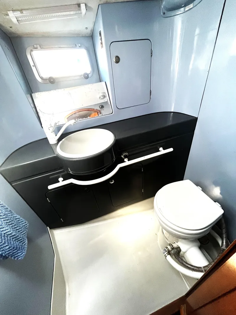 Slide: The Image of Bathroom interior of 1990 Jeanneau Sun Magic 44 yacht, featuring sink and toilet. - 11