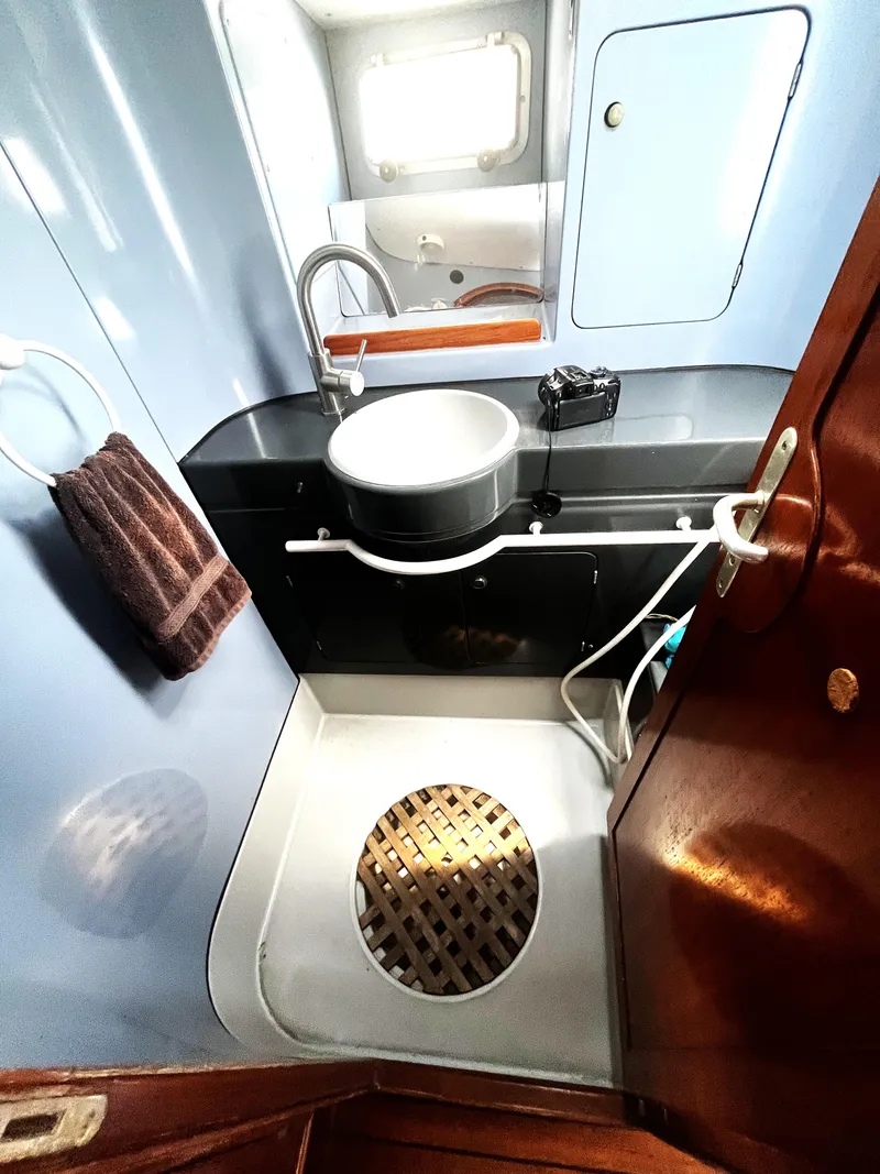 Slide: The Image of Bathroom interior of 1990 Jeanneau Sun Magic 44 yacht with sink and porthole. - 12