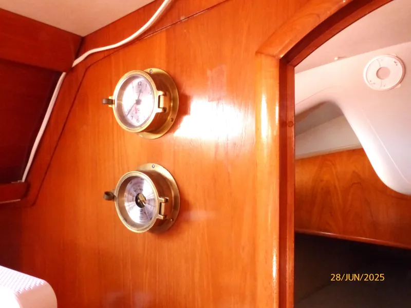 Slide: The Image of Interior of 1990 Jeanneau Sun Magic 44 yacht with brass instruments on wooden panel. - 16