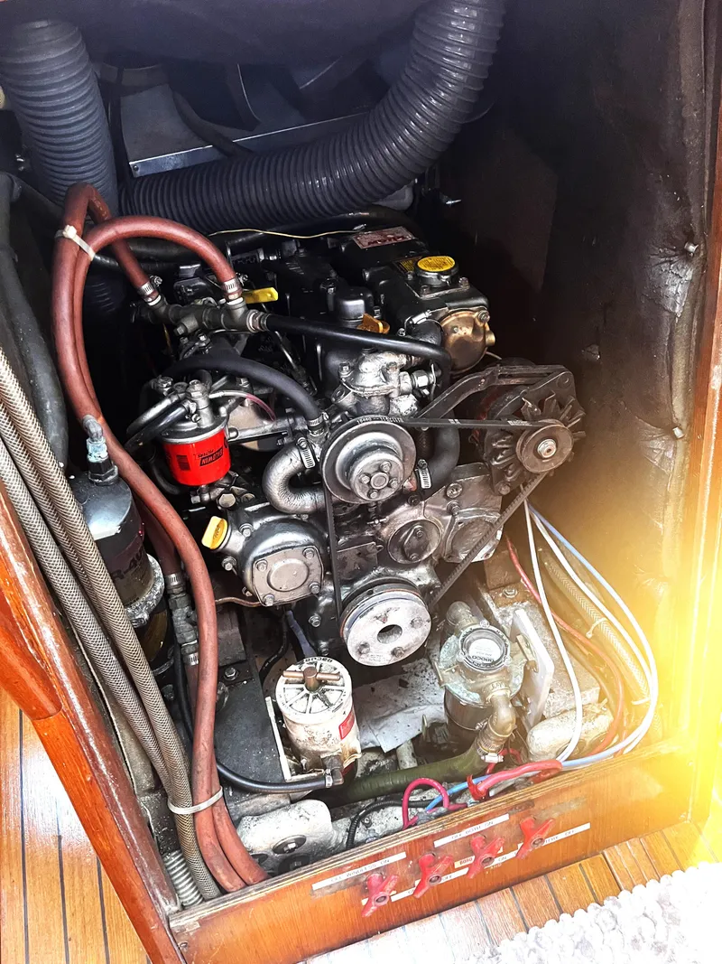 Slide: The Image of Engine compartment of a 1990 Jeanneau Sun Magic 44 sailboat, showing mechanical components. - 17