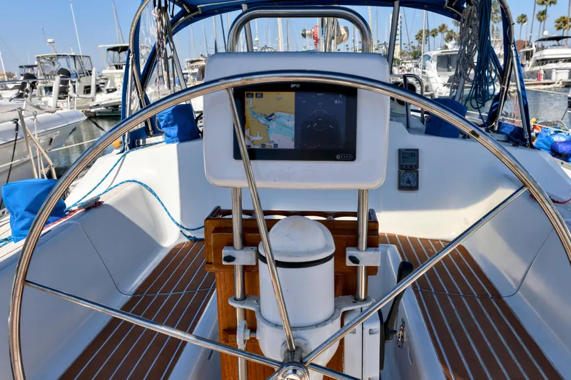 Slide: The Image of Cockpit of 1990 Jeanneau Sun Magic 44 sailboat with navigation equipment and steering wheel. - 23