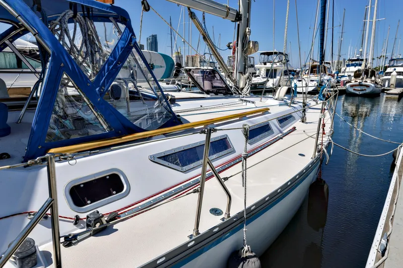 Slide: The Image of Jeanneau Sun Magic 44 sailboat docked in marina, 1990 model, with blue canopy. - 29