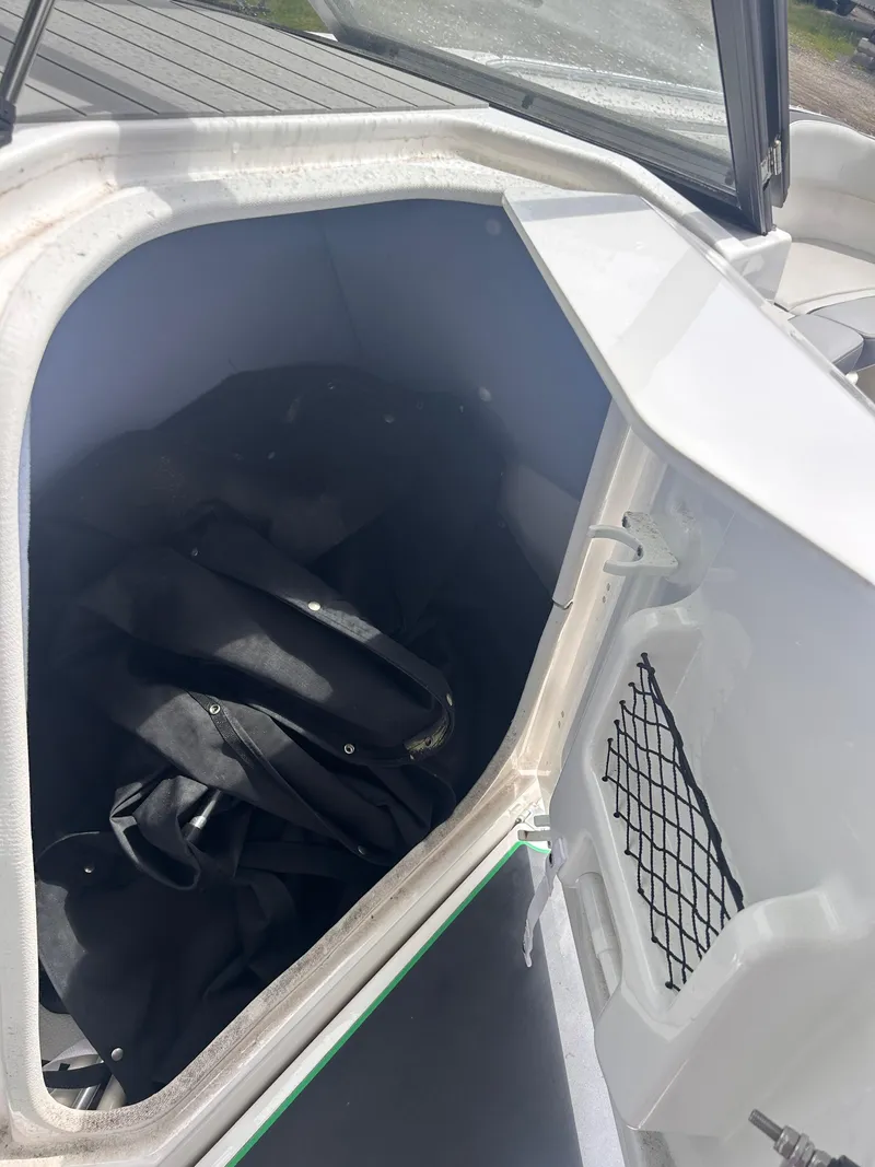 Slide: The Image of 2021 Yamaha AR250 boat storage compartment with black bag inside. - 3