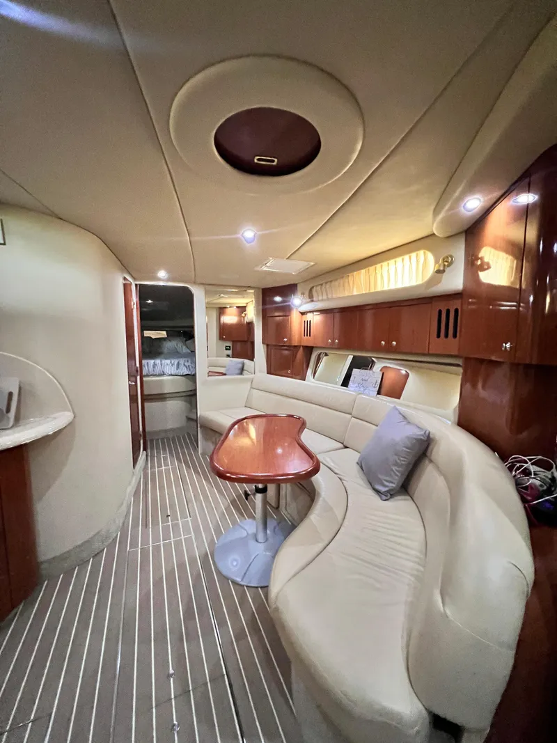 Slide: The Image of Luxurious interior of 2002 Sea Ray 410 Sundancer yacht with elegant seating and wood finishes. - 18
