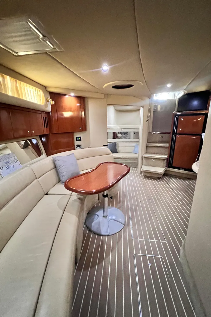 Slide: The Image of Interior of 2002 Sea Ray 410 Sundancer yacht with elegant seating and wooden finishes. - 20