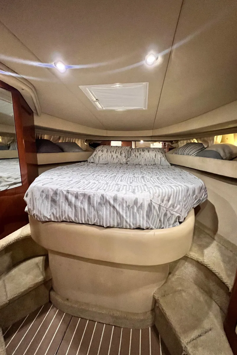 Slide: The Image of Luxurious cabin interior of 2002 Sea Ray 410 Sundancer yacht with cozy bed and ambient lighting. - 21