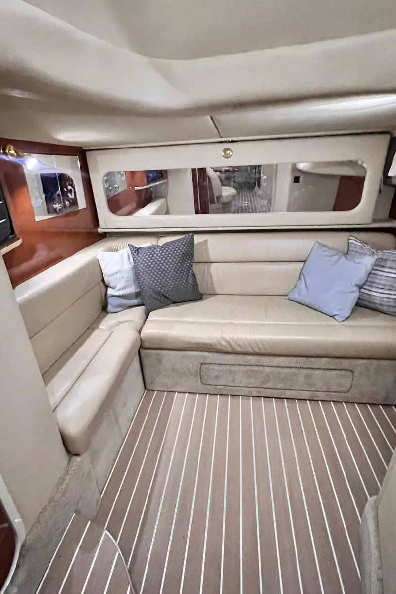 Slide: The Image of 2002 Sea Ray 410 Sundancer interior with beige seating and striped flooring. - 22