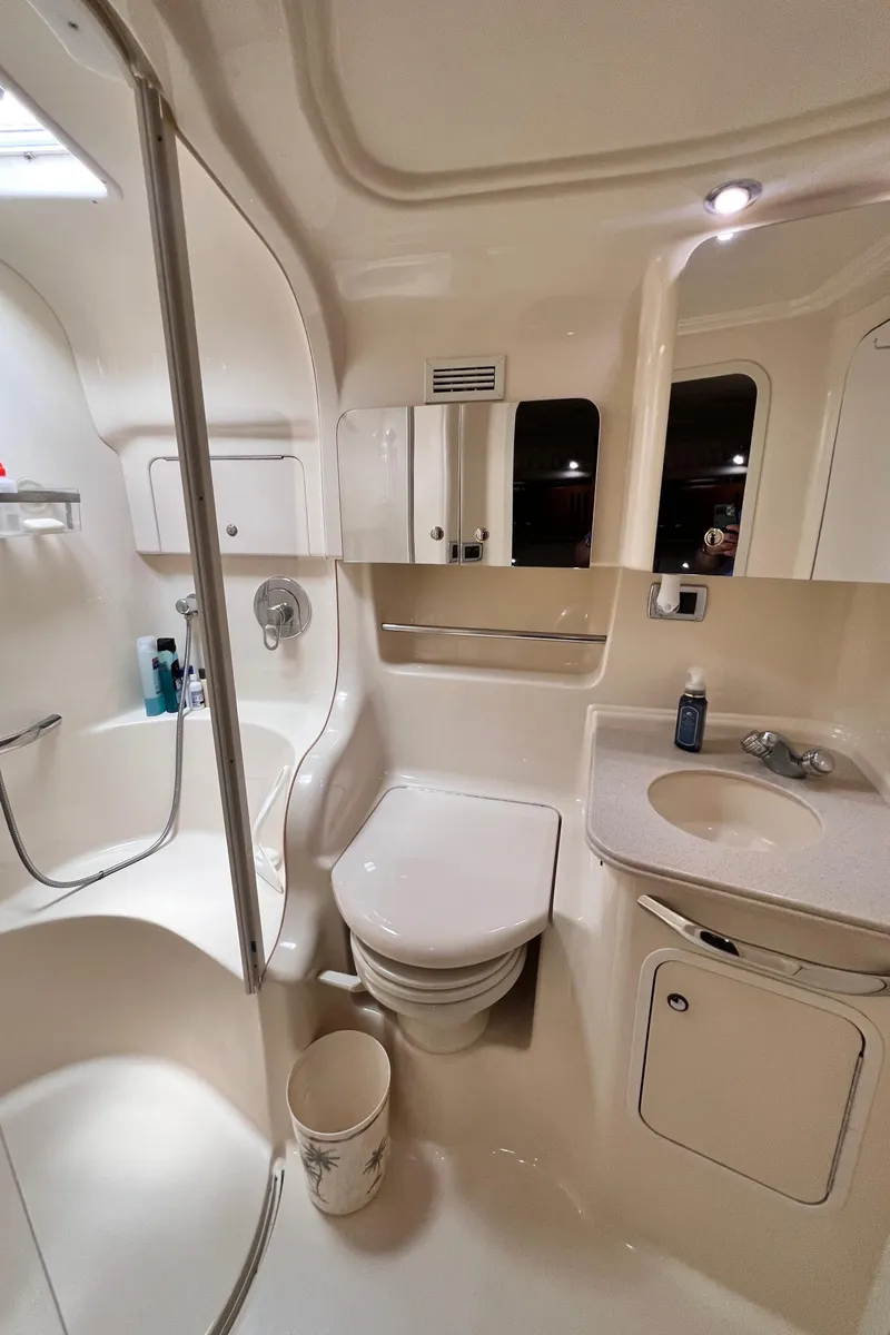 Slide: The Image of Luxurious bathroom in 2002 Sea Ray 410 Sundancer yacht, featuring shower, toilet, and sink. - 23