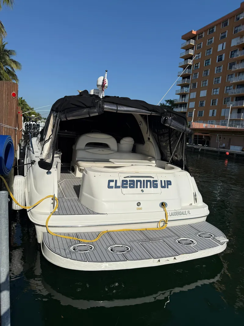 Slide: The Image of 2002 Sea Ray 410 Sundancer docked near waterfront building. - 3