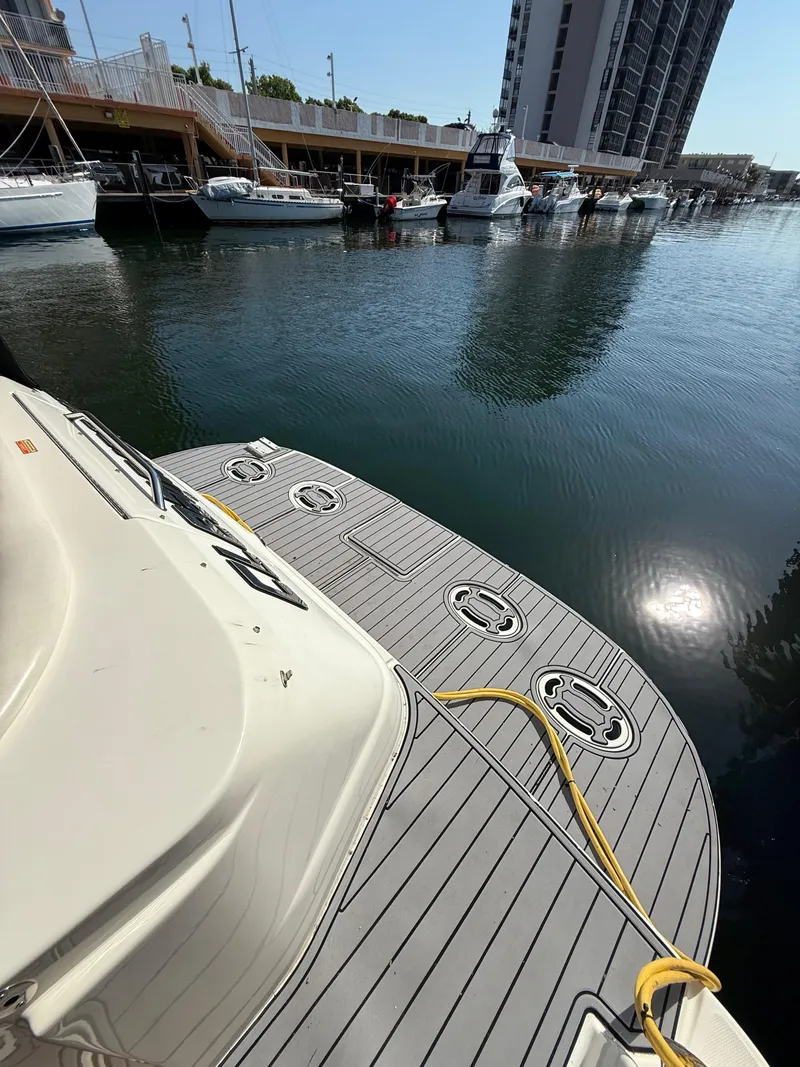 Slide: The Image of 2002 Sea Ray 410 Sundancer docked at marina with modern deck design. - 4