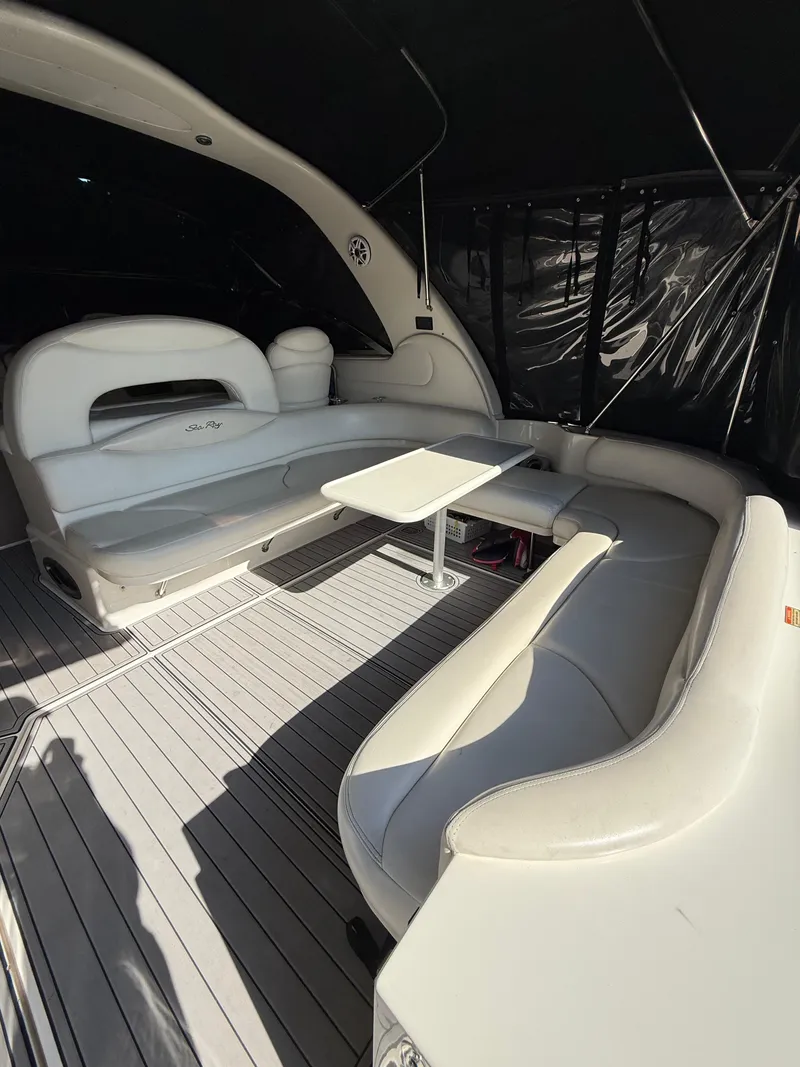 Slide: The Image of 2002 Sea Ray 410 Sundancer interior with white seating and table. - 8
