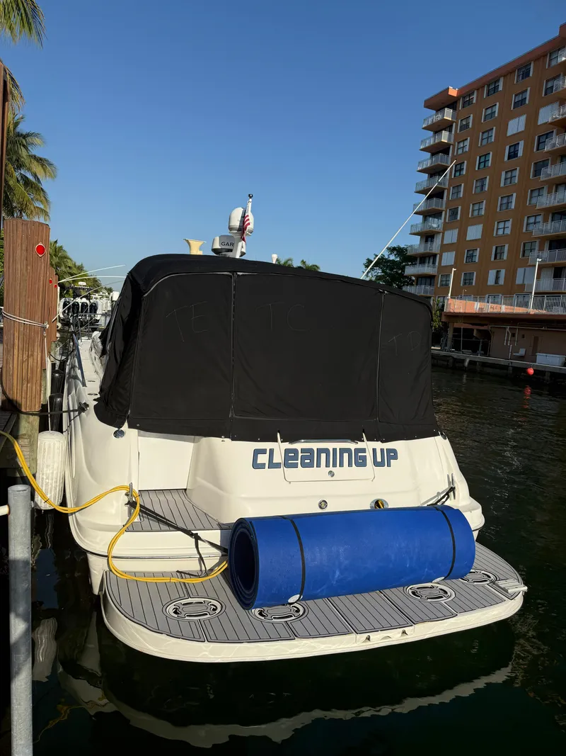 Slide: The Image of 2002 Sea Ray 410 Sundancer docked near waterfront building. - 9