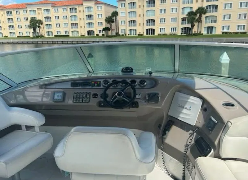 Slide: The Image of Pilothouse of 2000 Carver 450 Voyager with modern controls, overlooking waterfront buildings. - 2