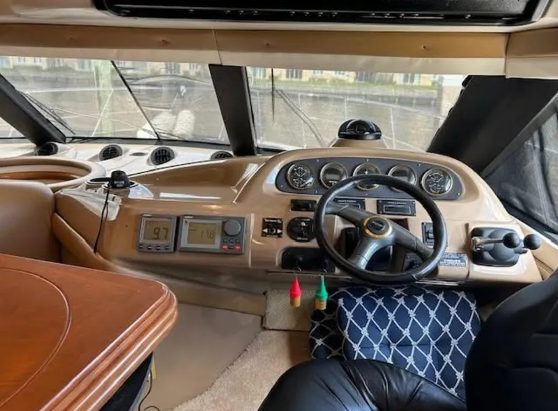 Slide: The Image of Interior of 2000 Carver 450 Voyager Pilothouse with steering wheel and navigation instruments. - 4