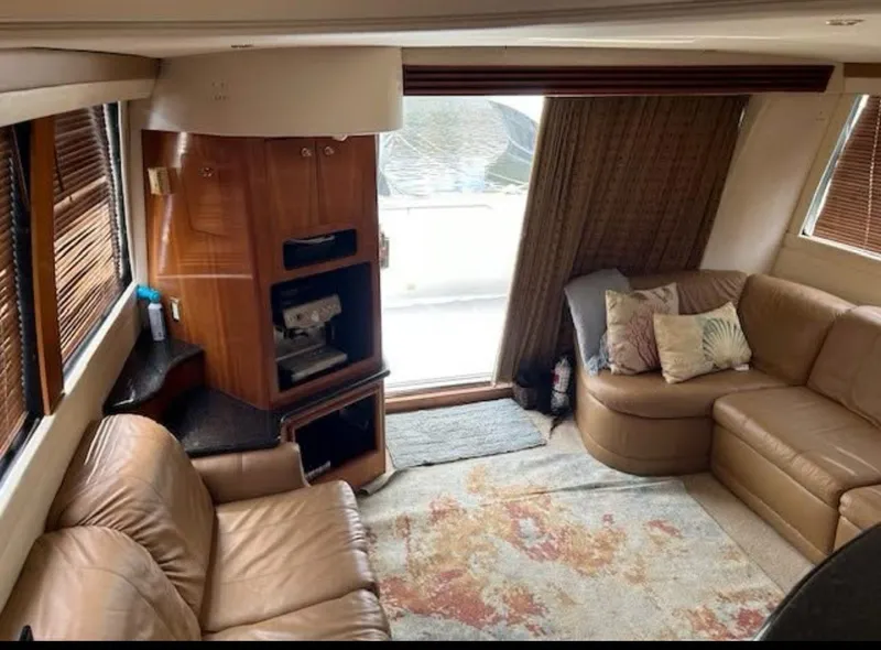 Slide: The Image of Luxurious interior of 2000 Carver 450 Voyager Pilothouse with leather seating and wood accents. - 5